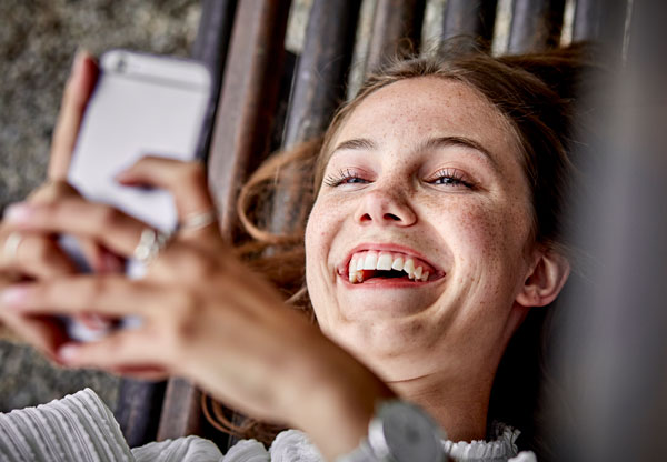 Women looking at web page on cell phone